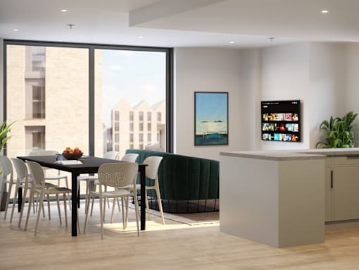 A modern dining room with a table set for four and a television displaying a news program.