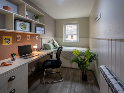 A small room with a desk and a chair.