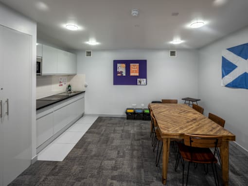 A conference room with a long table and chairs.