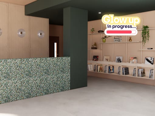 A room with a green wall and a shelf with books and plants.