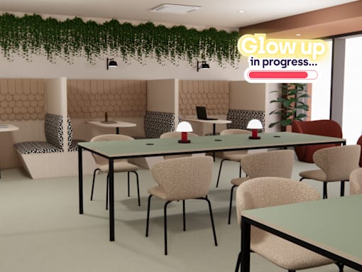 A conference room with a long table and chairs, a green plant, and a sign that says "Glow up in progress...".