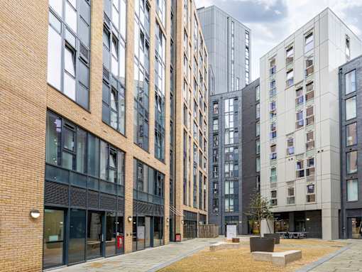 A modern building with a mix of brick and glass facades.