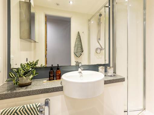 A bathroom with a white sink and a mirror above it.