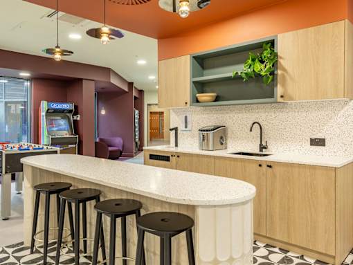 A kitchen with a counter and bar stools.