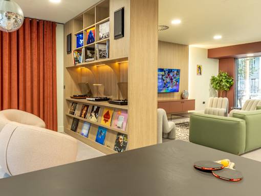 A living room with a grey table and a white sofa.