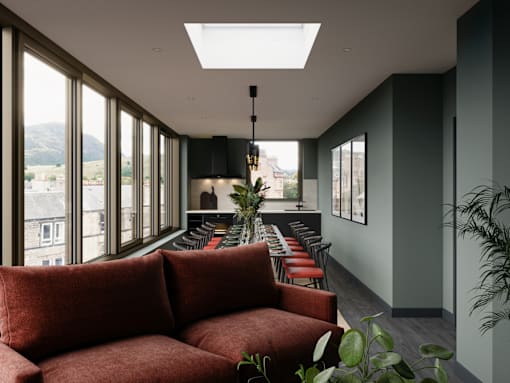 A long red couch is in a room with a skylight.