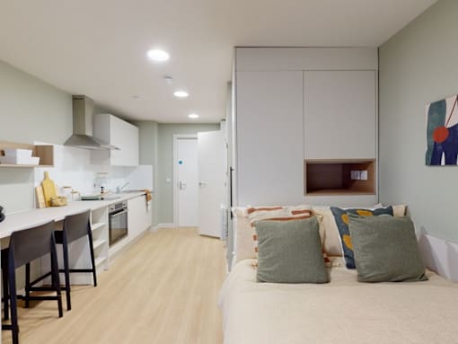 A kitchen with a dining table and chairs is shown.