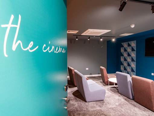 Entrance of the cinema room with lined up soft seating
