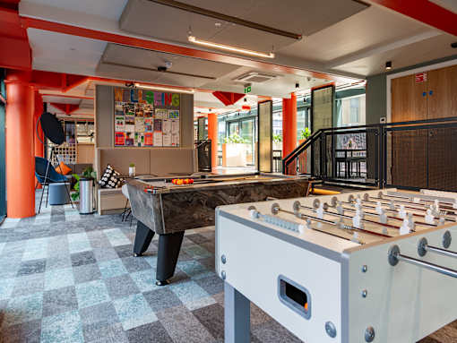 Two games tables in a room, one pool table and