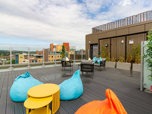 A patio with bean bag chairs and tables.