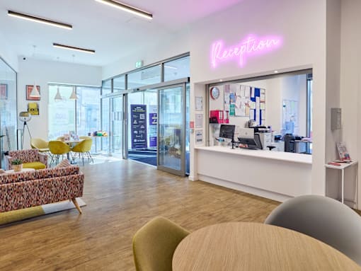 A reception area with a neon sign that says "Reception".