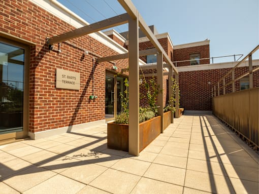 A brick building with a sign that says St. Bart's Terrace.
