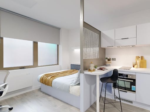 A modern bedroom with a built-in desk and chair.