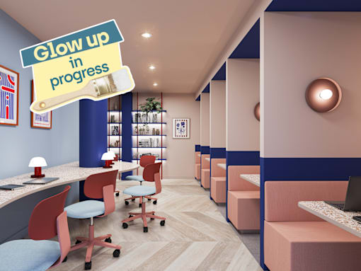 A modern office space with a sign that says "Glow up in progress".