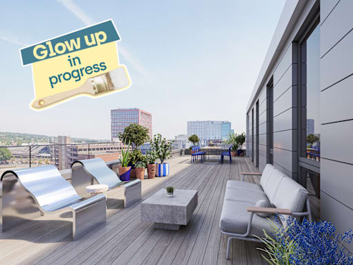 A rooftop patio with a sign that says "Glow up in progress".