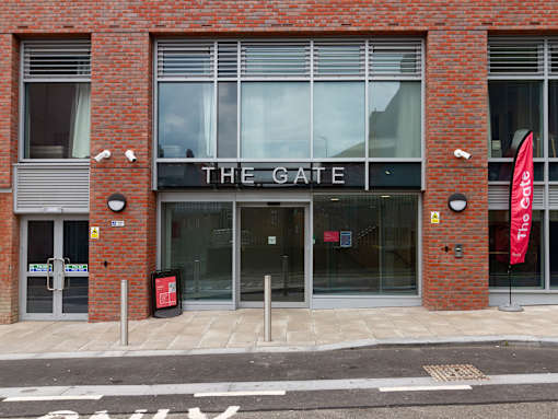 The front of a building with a sign that says The Gate.