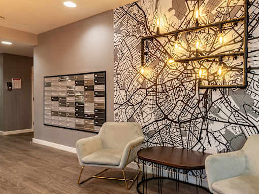 A wall with a map design and a light fixture above a table.