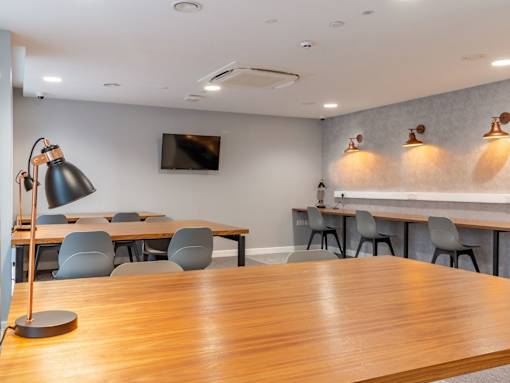A conference room with a long table and chairs.