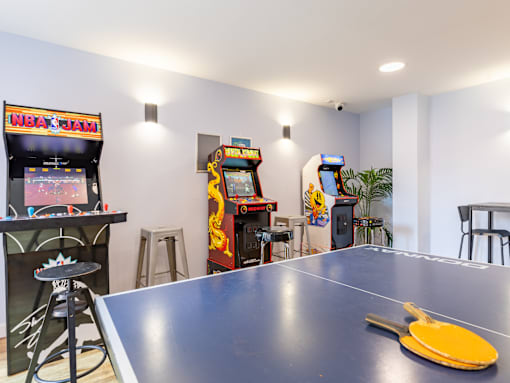A ping pong table with a yellow paddle on it.