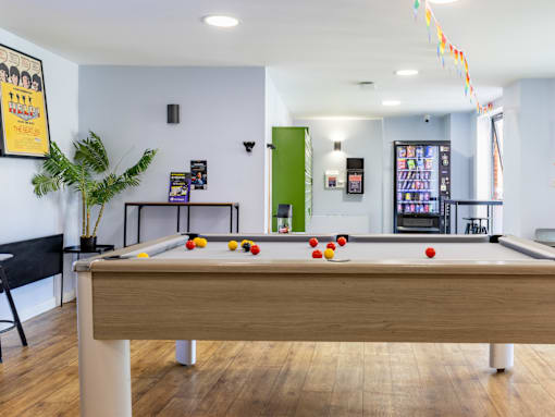 A pool table with balls set up in the middle of it.