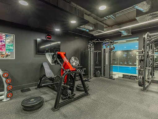 A gym with a variety of equipment including a leg press machine.