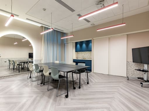 A conference room with a long table and chairs.