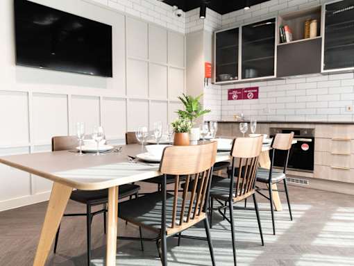 A modern dining area with a long table and chairs.