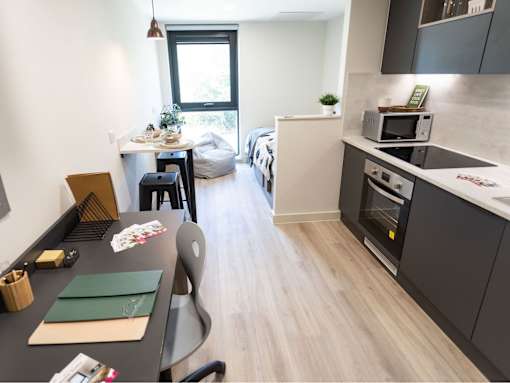 A modern kitchen with a dining table and chairs.