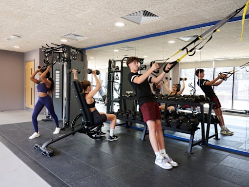 A group of people exercising in a gym.