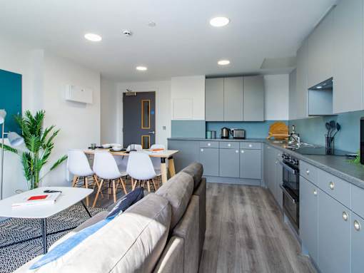 A modern kitchen with a dining table and chairs.