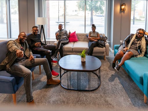 Four people sitting in a waiting room.
