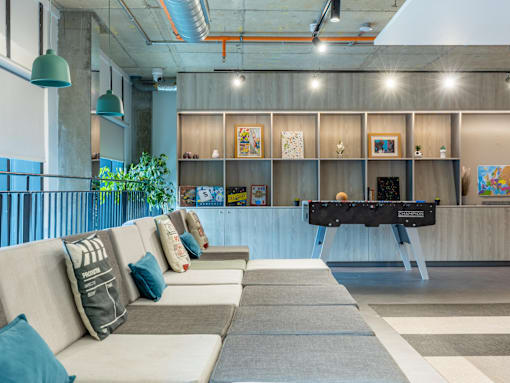 A modern living room with a long couch and a coffee table.