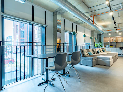 A modern office space with a table and chairs.