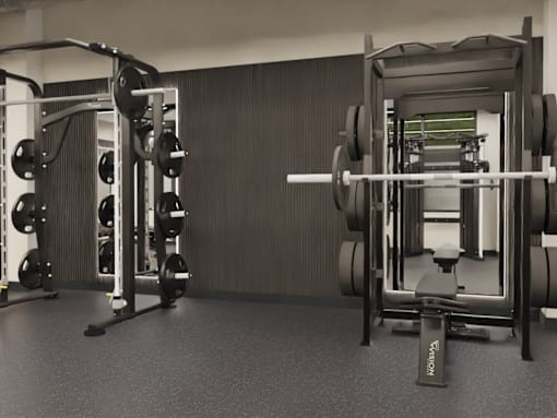 A black and white image of a gym with weightlifting equipment.