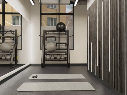 A gym with a white mat and a black ball on it.