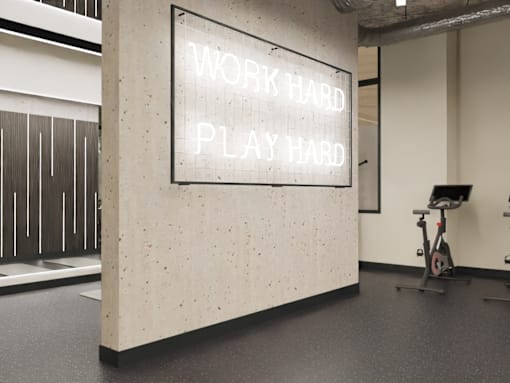 A sign in a gym that says "work hard play hard".
