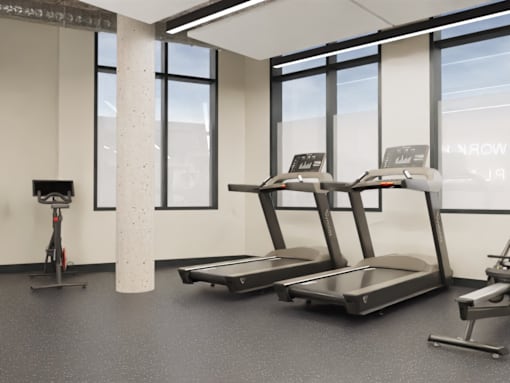 A gym with treadmills and a stationary bike.