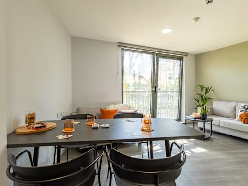 A modern dining room with a large table and chairs.