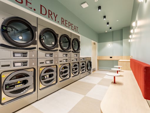 A row of washing machines in a laundromat.