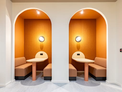A room with two tables and two chairs.