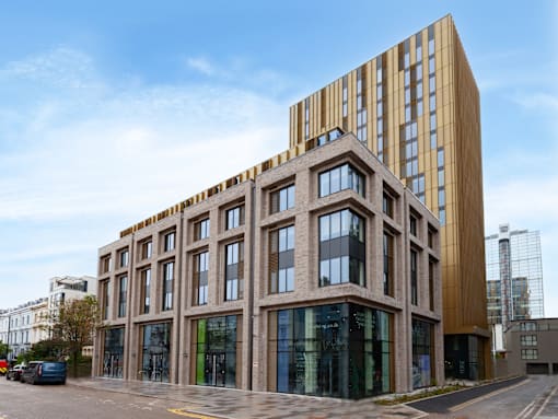 A modern building with a mix of brown and glass windows.