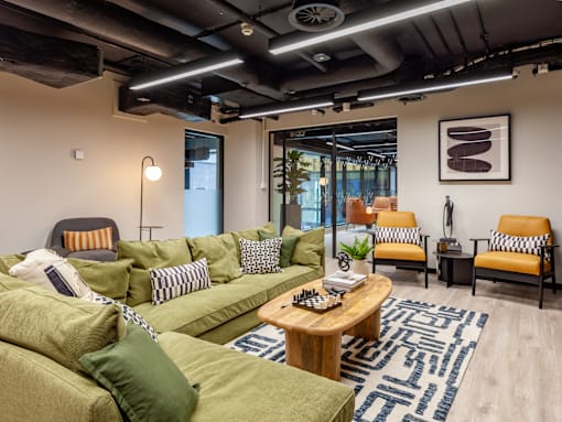 A social area
 with a green couch and a coffee table.