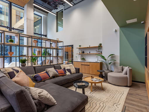 A social area with a grey couch and a coffee table.
