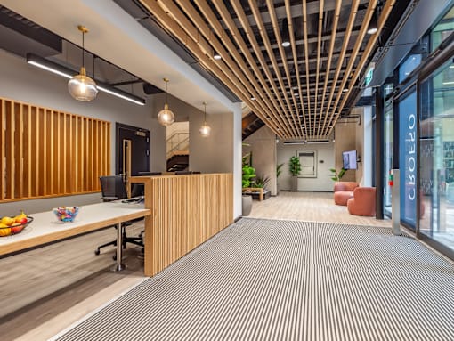 A hallway with reception and panelled ceilings.