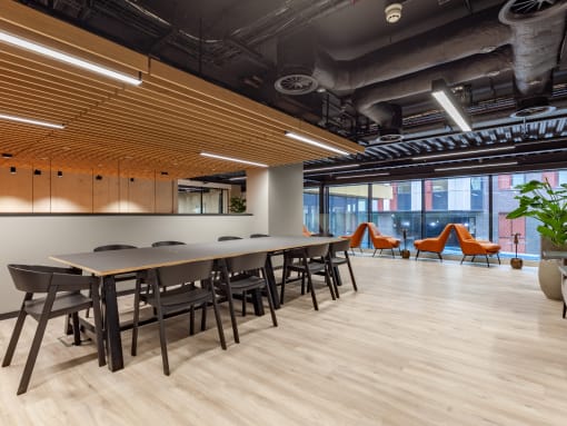 a large meeting room with long tables and chairs