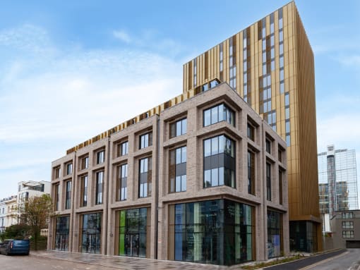 a brick building in front of a tall building