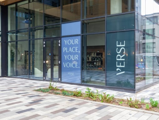 a building with a sign that says your place your voice on the side of it