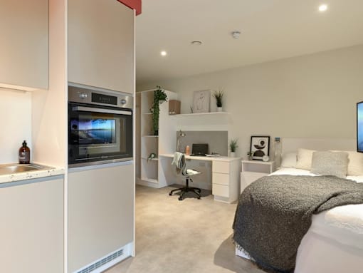 A modern kitchen with a large island and a television.