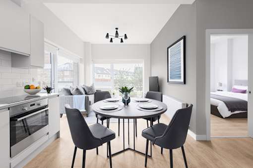 a living room and dining room with a table and chairs