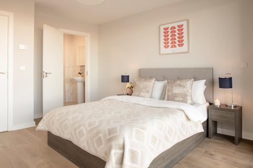 a bedroom with a bed and a door to a bathroom